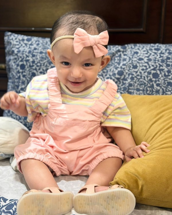 Nazia in pink overalls